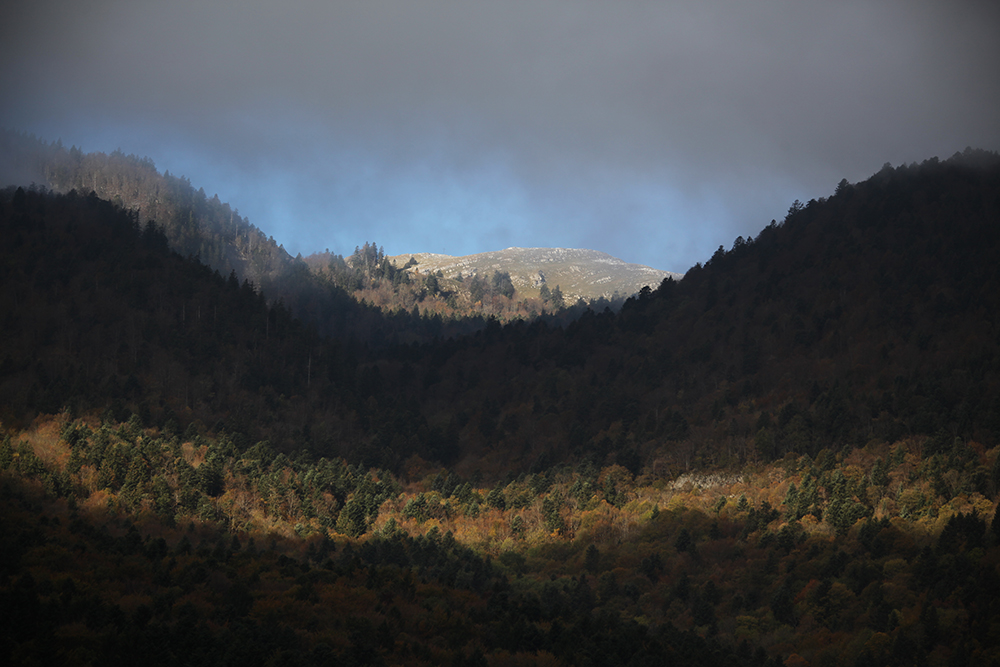 Sunlight plays across the mountains of the Jura.